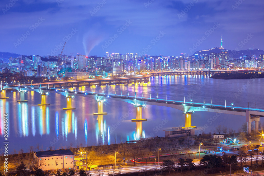 Seoul city and Cars passing on The bridge and Traffic, Han River at Night in Downtown Seoul, South Korea.