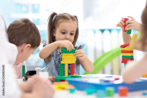Little children build woode...
