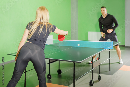 table tennis. man and woman compete in a ping pong game. horse competition.