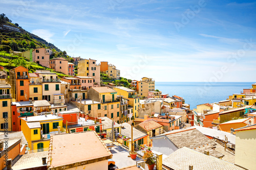 Riomaggiore, Liguria, Italy fisherman village, colorful houses on sunny warm day. Monterosso al Mare, Vernazza, Corniglia, Manarola, and Riomaggiore, Cinque Terre National Park UNESCO World Heritage