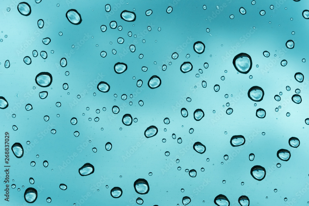 Blue background, Natural water drop on glass. Blue background, Natural water drop on glass.
