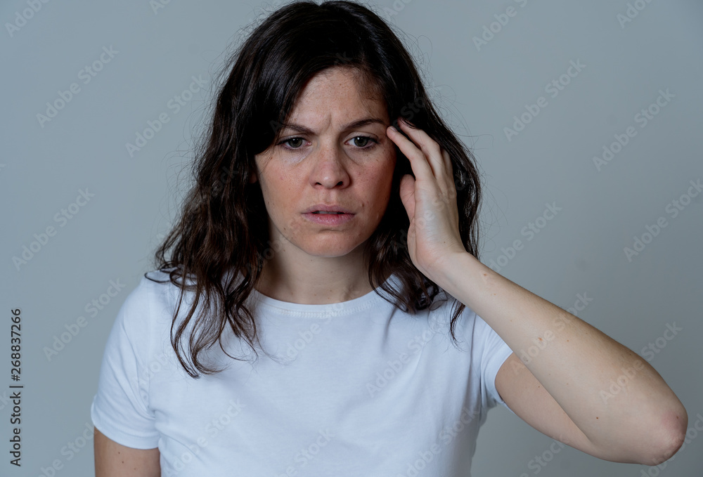 Portrait of sad and depressed woman. Isolated on neutral background. Human expressions and emotions Portrait of sad and depressed woman. Isolated on neutral background. Human expressions and emotions