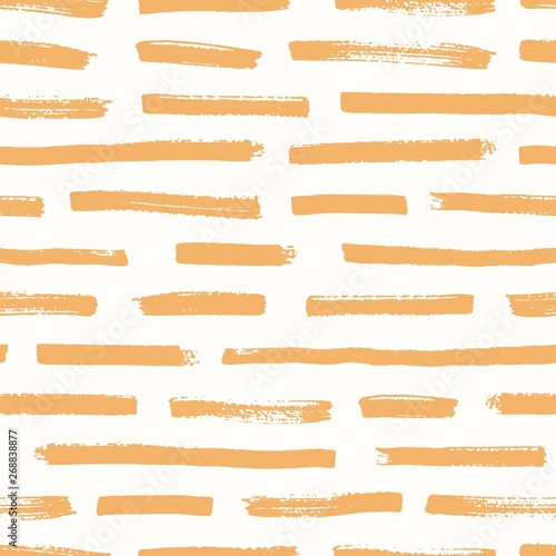 Artistic seamless pattern with orange brush strokes on white background. Deco...