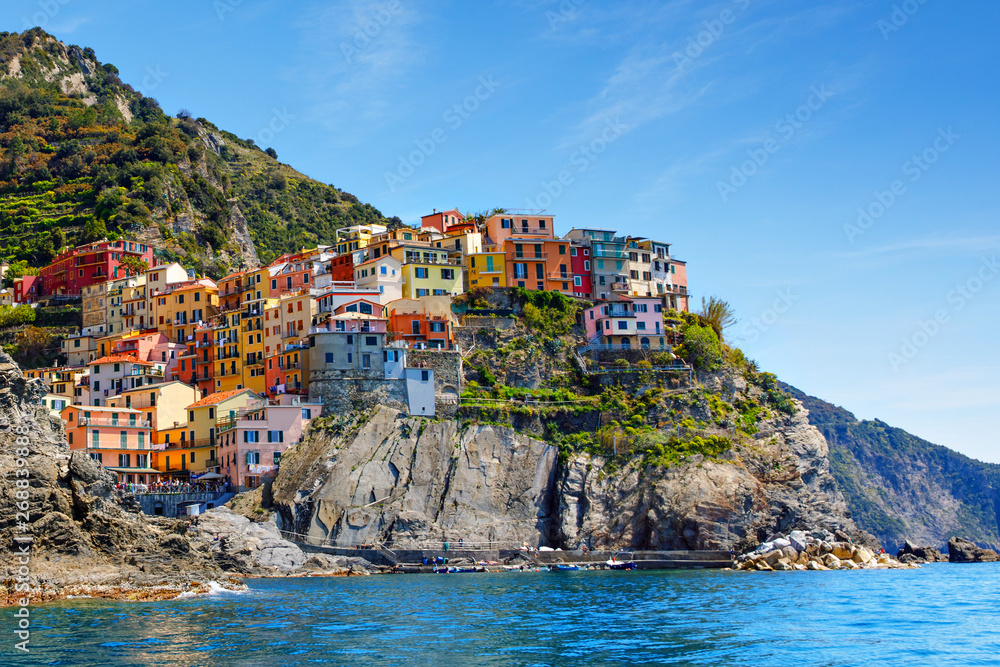 Manarola, Liguria, Italy fisherman village, colorful houses on sunny warm day. Monterosso al Mare, Vernazza, Corniglia, Manarola and Riomaggiore, Cinque Terre National Park UNESCO World Heritage