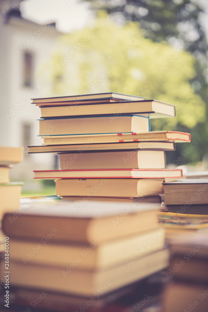 Stack of books at a charity book flea market, text space Stack of books at a charity book flea market, text space