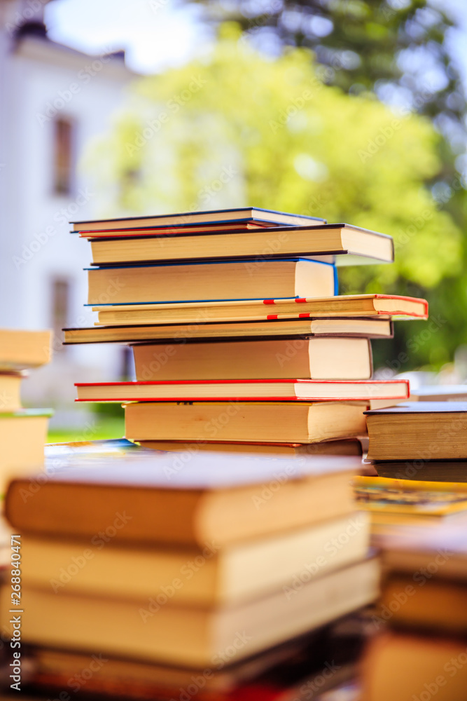 Stack of books at a charity book flea market, text space Stack of books at a charity book flea market, text space
