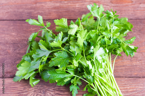 bunch of fresh green parsley on wooden background