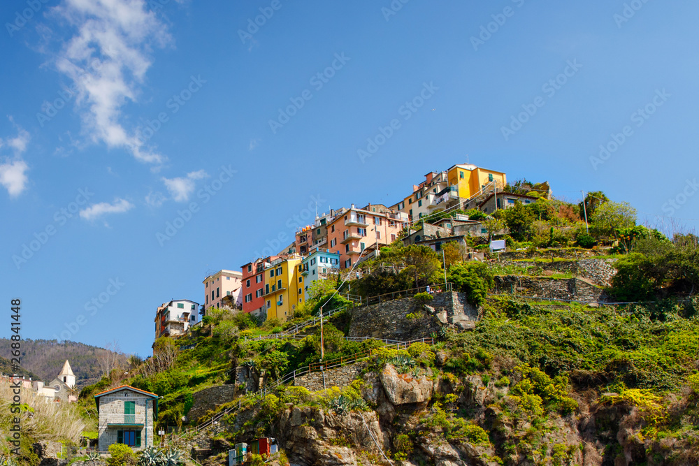 Corniglia, Liguria, Italy fisherman village, colorful houses on sunny warm day. Monterosso al Mare, Vernazza, Corniglia, Manarola and Riomaggiore, Cinque Terre National Park UNESCO World Heritage