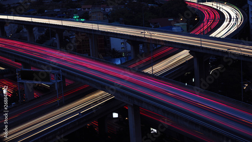 Motion blur of car light in city highway at dawn. Cross intersection of urban highways.