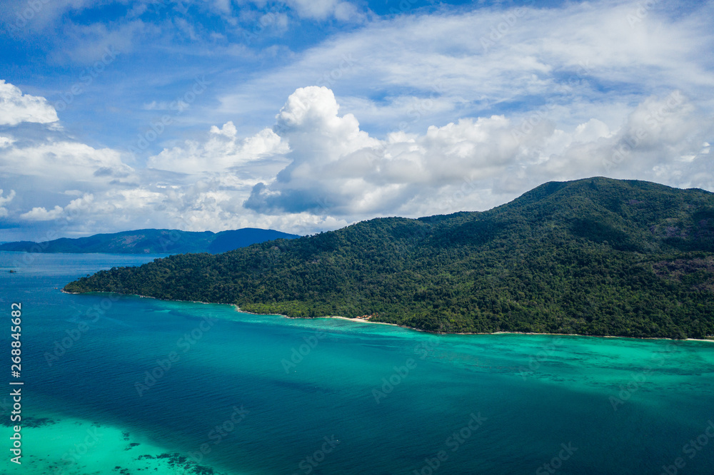 Fototapeta premium Aerial drone view of beautiful green Koh Usen island with amazing lagoon sea over summer sky background, Thailand