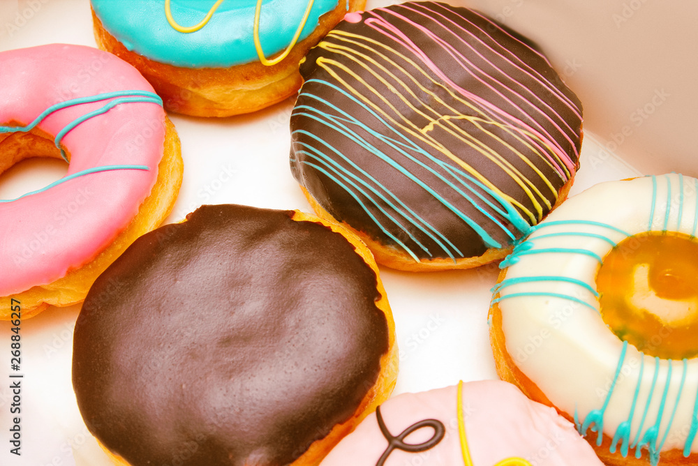 Variety of donuts and Boston cream pie or Chocolate donut without a