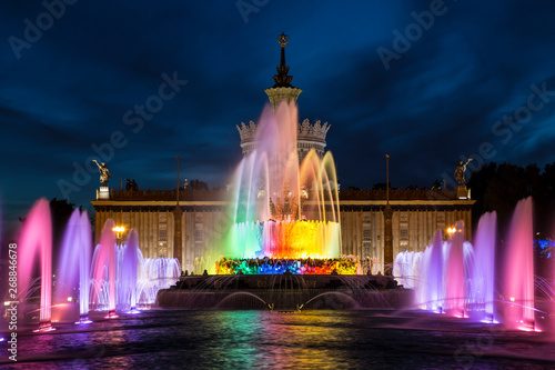 Fountain "Stone flower" on the background of the pavilion "Ukraine" on the territory of the All-Russian exhibition center (VDNH) at night. Moscow, Russia
