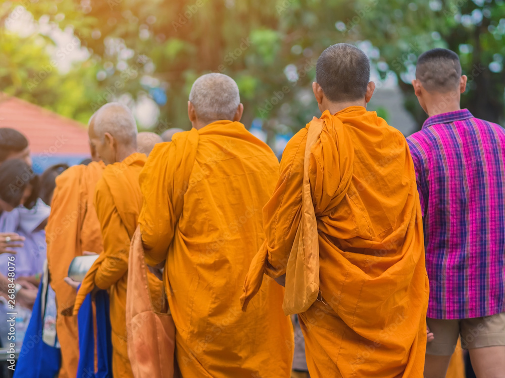 Teachers and students together make merit to give food offerings to a Buddhist monk on important religious days at school. Teachers and students together make merit to give food offerings to a Buddhist monk on important religious days at school.