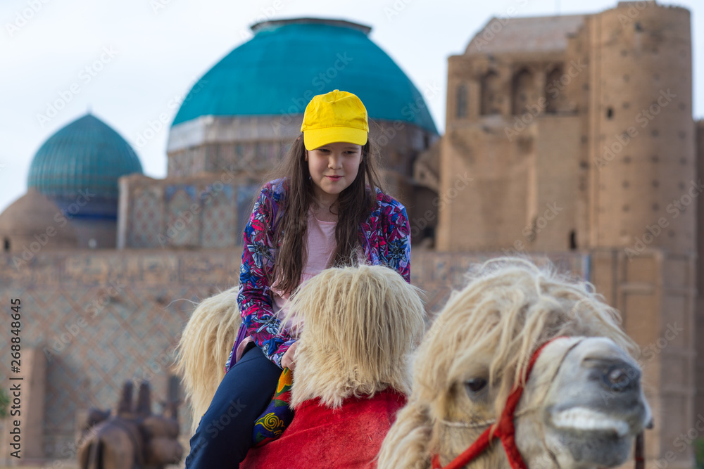 little girl riding a camel