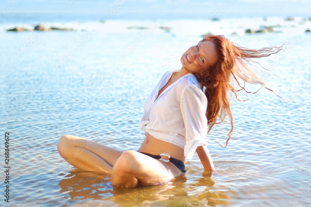 Naklejka premium Young pretty woman in white shirt