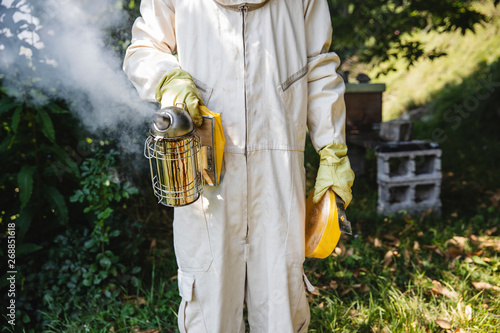 Man holding a bee smoker photo