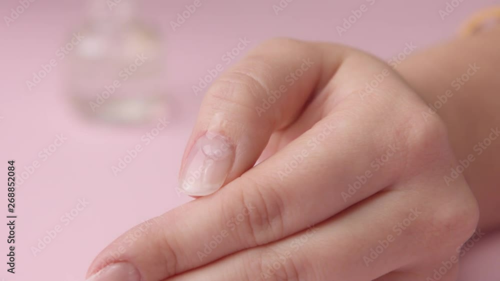 slowmotion closeup oil drop falling on cuticle zone slowmotion closeup oil drop falling on cuticle zone