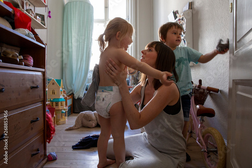 Mother and her kids in their bedroom