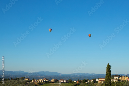Hot air balloons flying in the Chianti hills, Tuscany, Italy