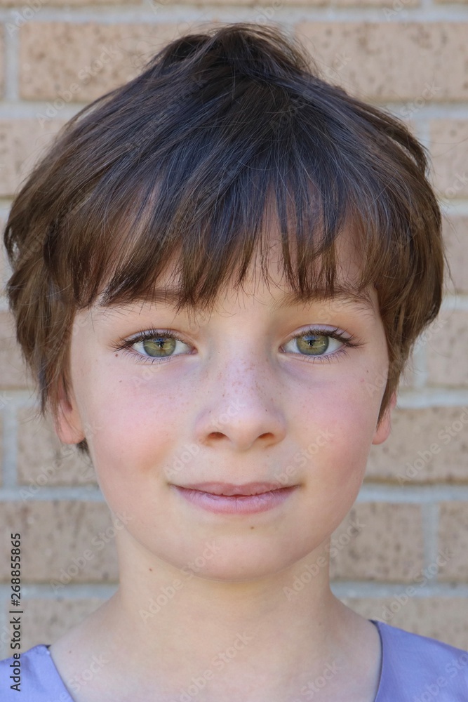 Portrait of a child with a brown pixie cut and big hazel eyes Portrait of a child with a brown pixie cut and big hazel eyes