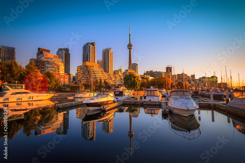 Fototapeta Naklejka Na Ścianę i Meble -  View of harbor in a yacht club at Toronto city during sunset with Canadian tower as background