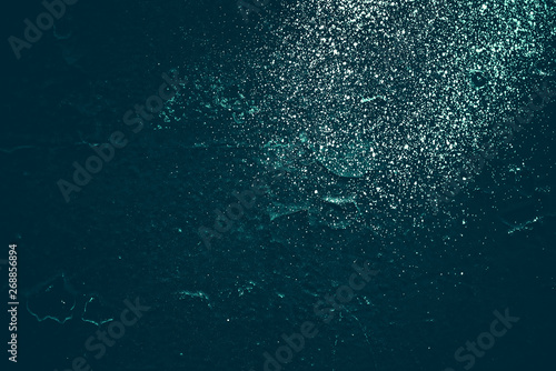 Vintage azure background. Rough painted wall of turquoise color. Imperfect plane of cyan colored. Uneven old decorative toned backdrop of aqzure tint. Texture of teal hue. Ornamental stony surface. © Daniil
