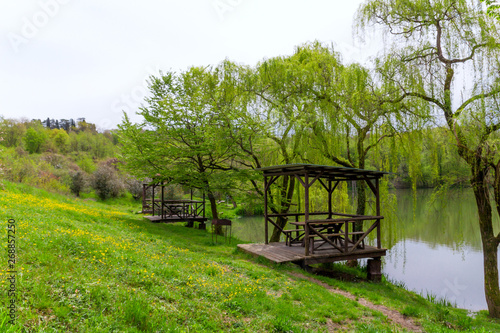 landscape with wooden gazebos by the lake