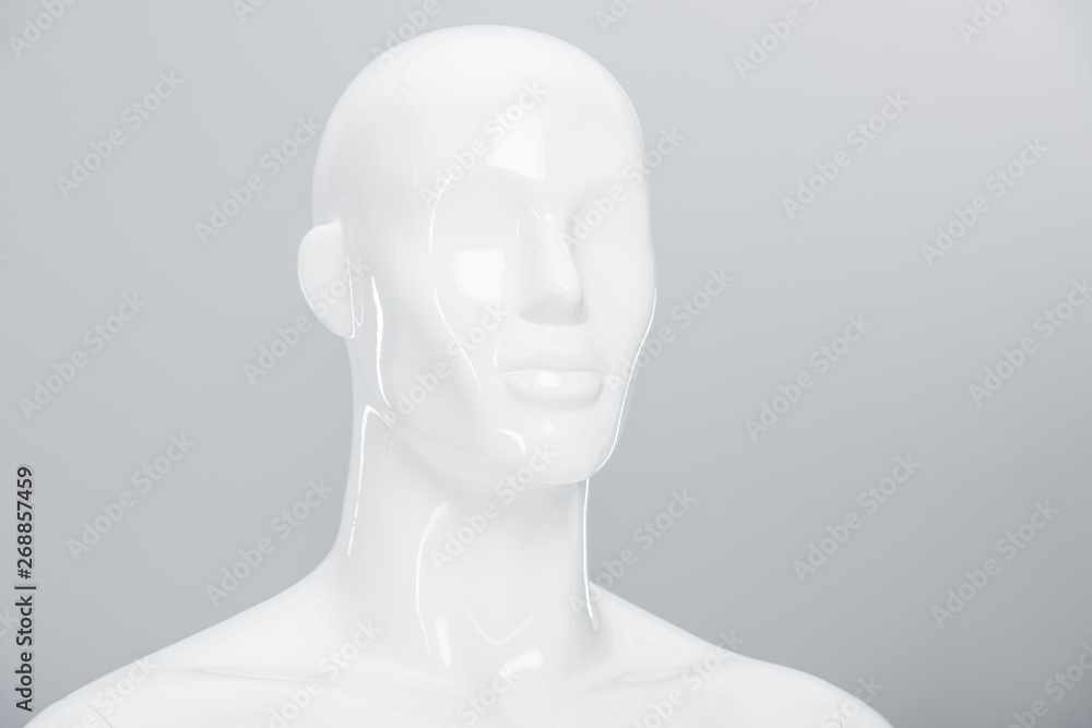 white plastic mannequin doll on grey with copy space white plastic mannequin doll on grey with copy space
