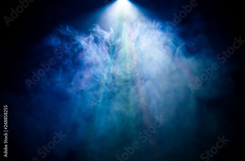 beautiful rainbow color spotlight wide lens projector with light beam for movie and cinema at night . abstract blue smoke texture . screening for multimedia . black background .