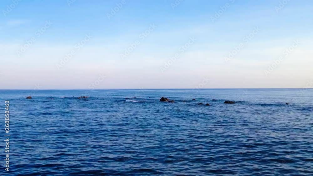 Blue Calm Sea Waves Of Rocky Beach Scenery Seamless Loop In The Morning At Umeanyar Village, North Bali, Indonesia Blue Calm Sea Waves Of Rocky Beach Scenery Seamless Loop In The Morning At Umeanyar Village, North Bali, Indonesia