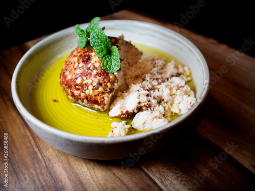 Shanklish cheese covered with zaatar and dried pepper in olive oil. Arabian cheese. photo