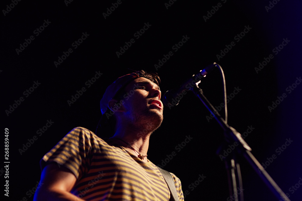 © Miquel Llonch/Stocksy - Musician and singer performing in a live concert © Miquel Llonch/Stocksy - Musician and singer performing in a live concert