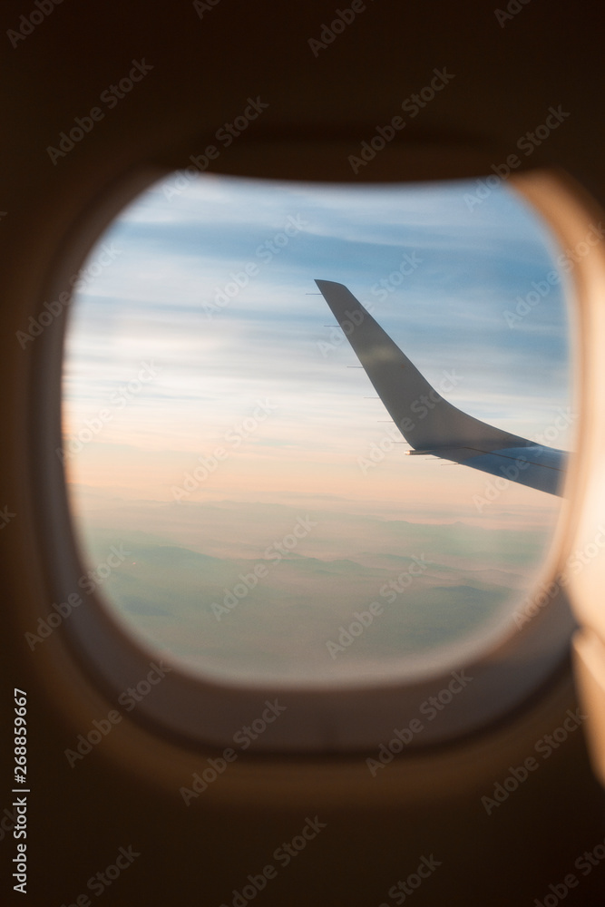 View to the sky and wing through the airplane window View to the sky and wing through the airplane window