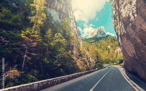 road in mountains  autumn forest a glowing in sunlight. Romania- Carpathian Mountains. Bicaz Canyon Cheile Bicazului . Beauty in the world. soft light effect. instagram filter