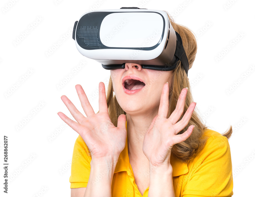 Surprised woman in virtual reality glasses. Portrait of young woman with VR headset. Happy girl using future technology, isolated on white background.