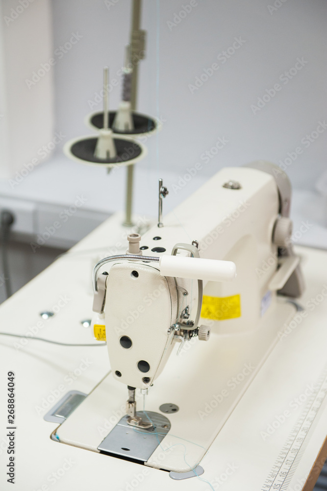 Industrial sewing machine in tailor's workshop