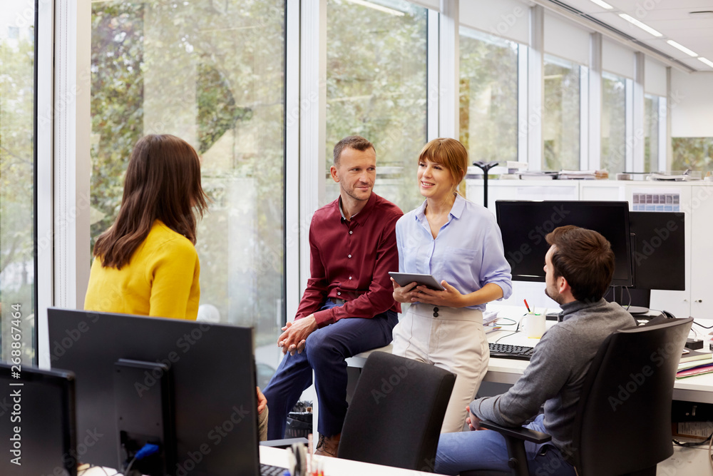 Smiling Businesswoman Discussing With Colleagues Smiling Businesswoman Discussing With Colleagues