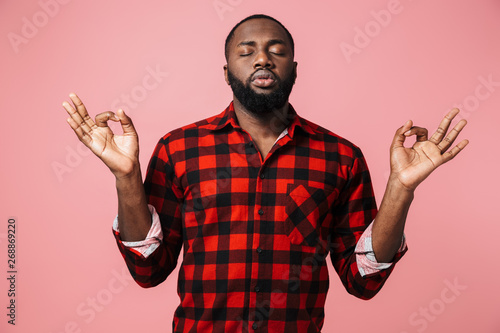 Portrait of a calm african man wearing plaid shirt photo