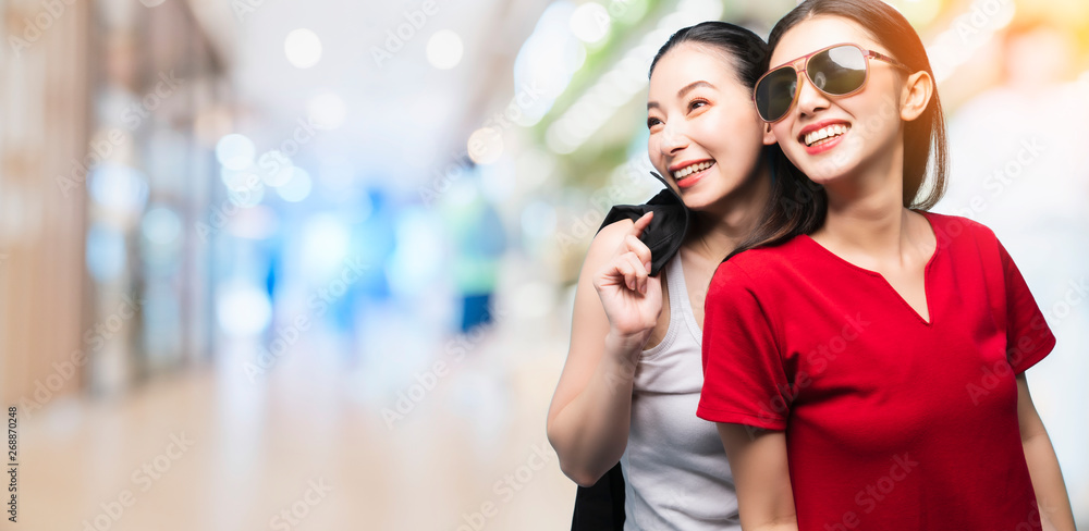 beautiful happy Asian girl holding coat jacket wear sun glasses enjoy summer time travel concept on color background beautiful happy Asian girl holding coat jacket wear sun glasses enjoy summer time travel concept on color background