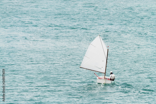 Boy in an optimist dinghy in English Harbour in Antigua