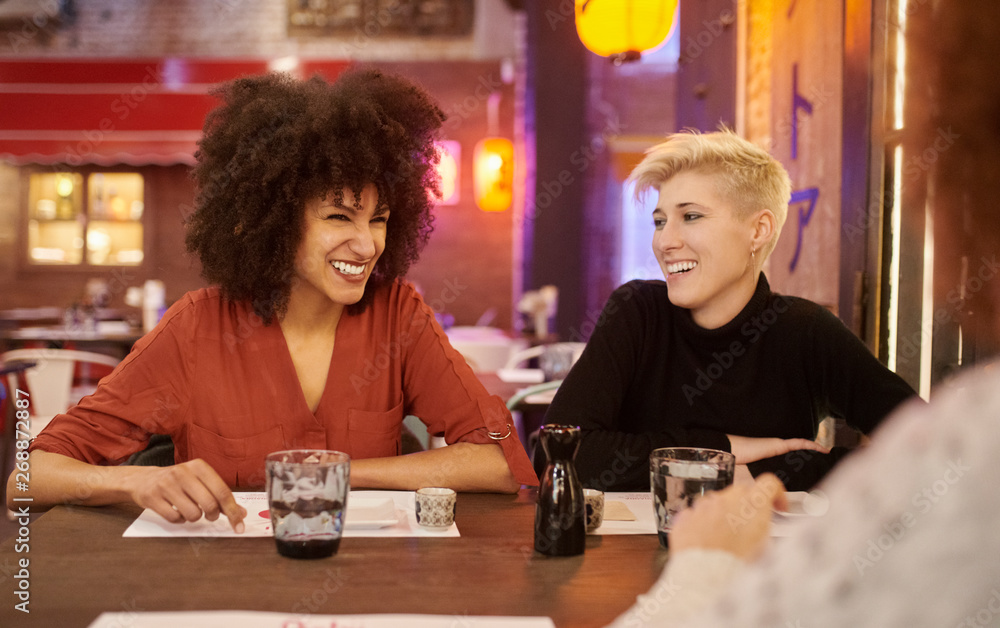 Laughing women relaxing in cafeteria Laughing women relaxing in cafeteria