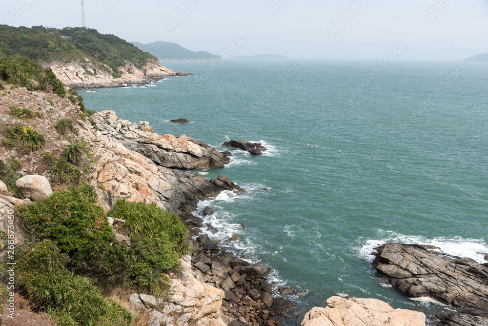 sea with trees and rocks around it in south of china