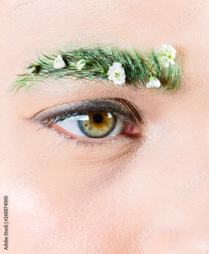 Decorative spring make up with 'garden' eyebrow look and flowers photo