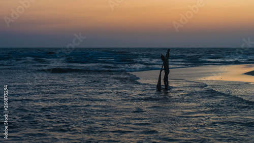 Fototapeta Naklejka Na Ścianę i Meble -  Fishingman catch fish with fishing net silhouette in ocean in Negombo, Sri Lanka