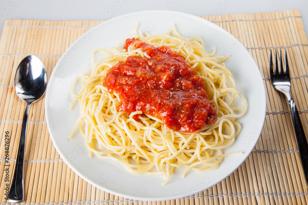 Macaroni with tomato sauce on white background Macaroni with tomato sauce on white background