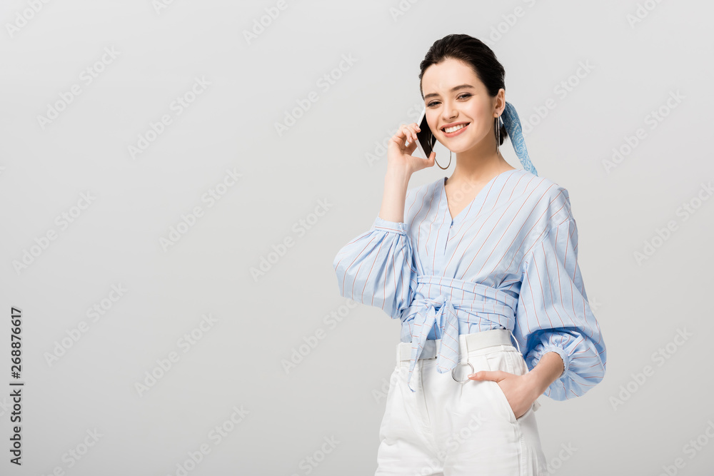 beautiful stylish girl talking on smartphone isolated on grey with copy space beautiful stylish girl talking on smartphone isolated on grey with copy space