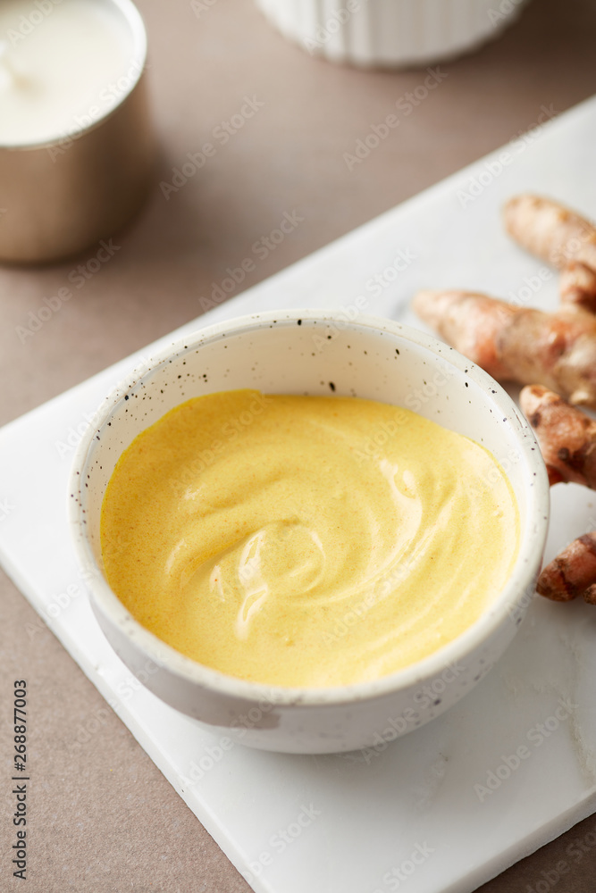 Close-up of facial turmeric mask with ginger roots. Close-up of facial turmeric mask with ginger roots.
