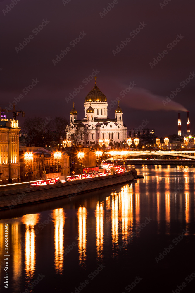 View onto illuminated Cathedral of Christ the Saviour during a dark winter evening with Moskva river (Moscow, Russia, Europe)