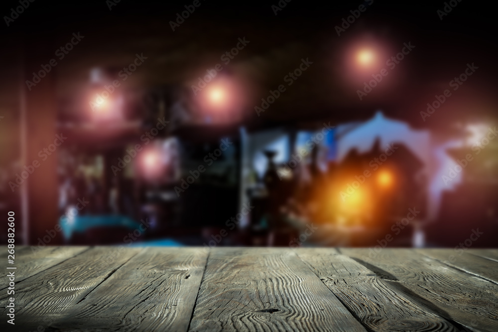 Desk of free space and blurred bar background Desk of free space and blurred bar background