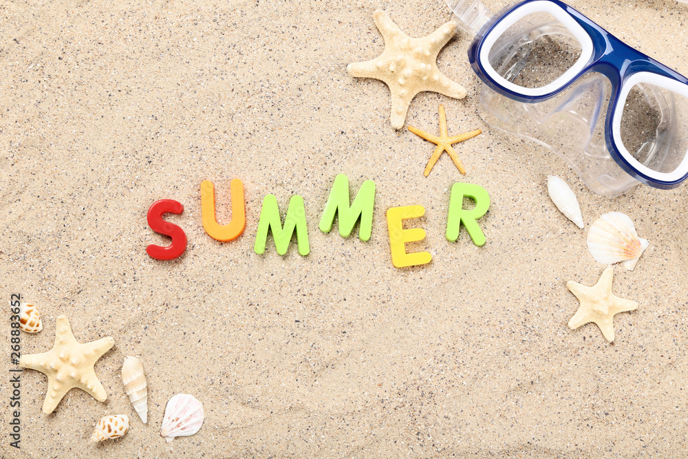 Word Summer with seashells and diving mask on beach sand Word Summer with seashells and diving mask on beach sand